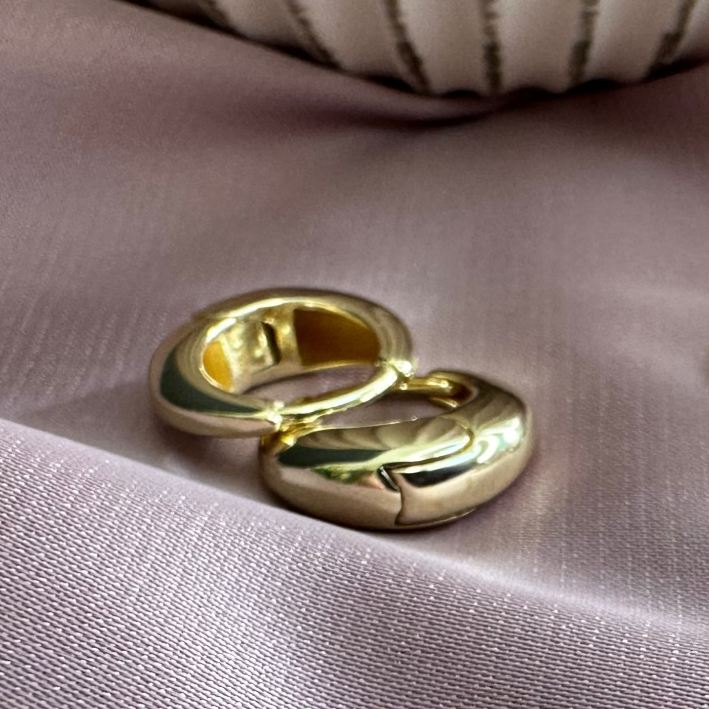 dome shaped huggies laid on pink ground