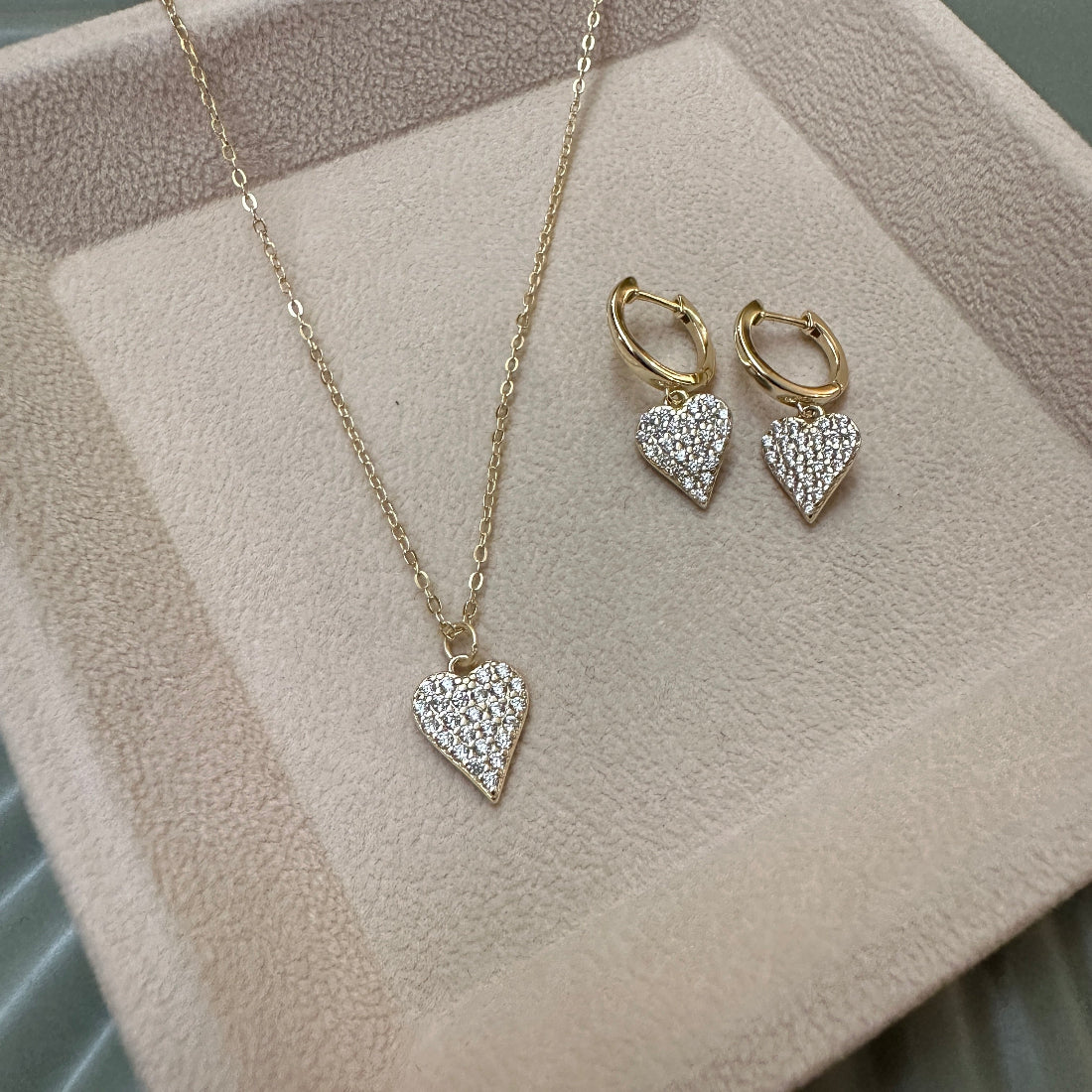 Heart-shaped sparkle fashionablejewellery set with necklace and earrings on a soft surface