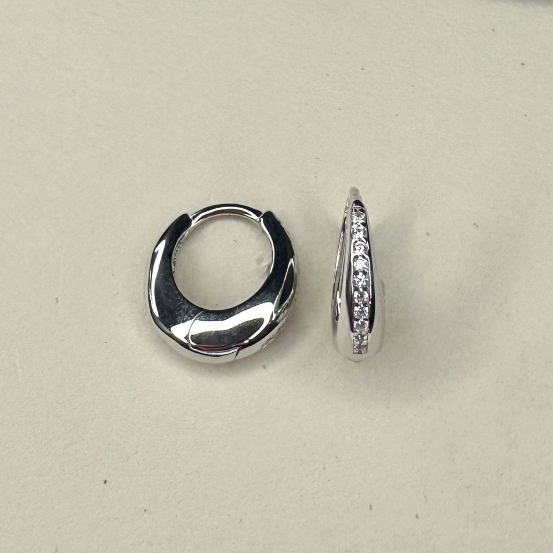 dome shaped huggies with channel set pave gemstones creating a modern silhouette on a white ground