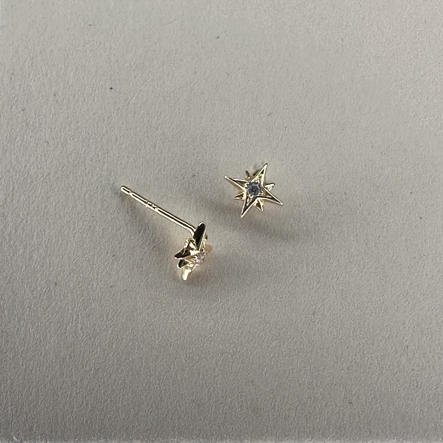 star studs with crystal centre laid on cream ground