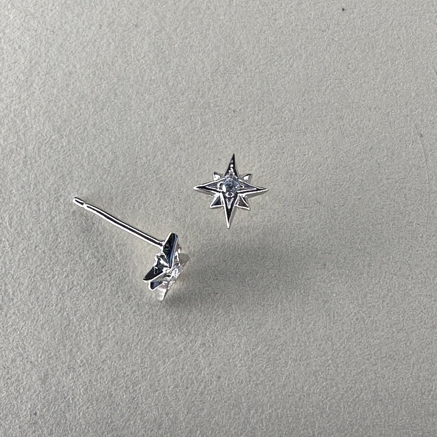 Star shaped studs with crystal centre on cream ground