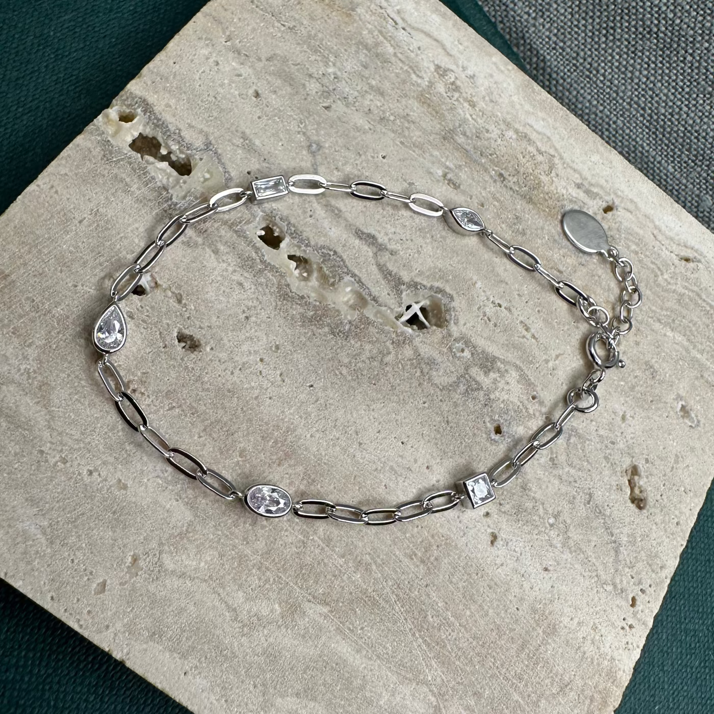 Silver bracelet on terazzo tile background