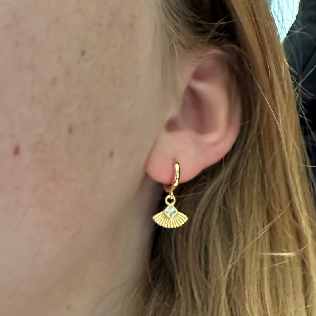 Art Deco Fan Huggie Earrings on a model