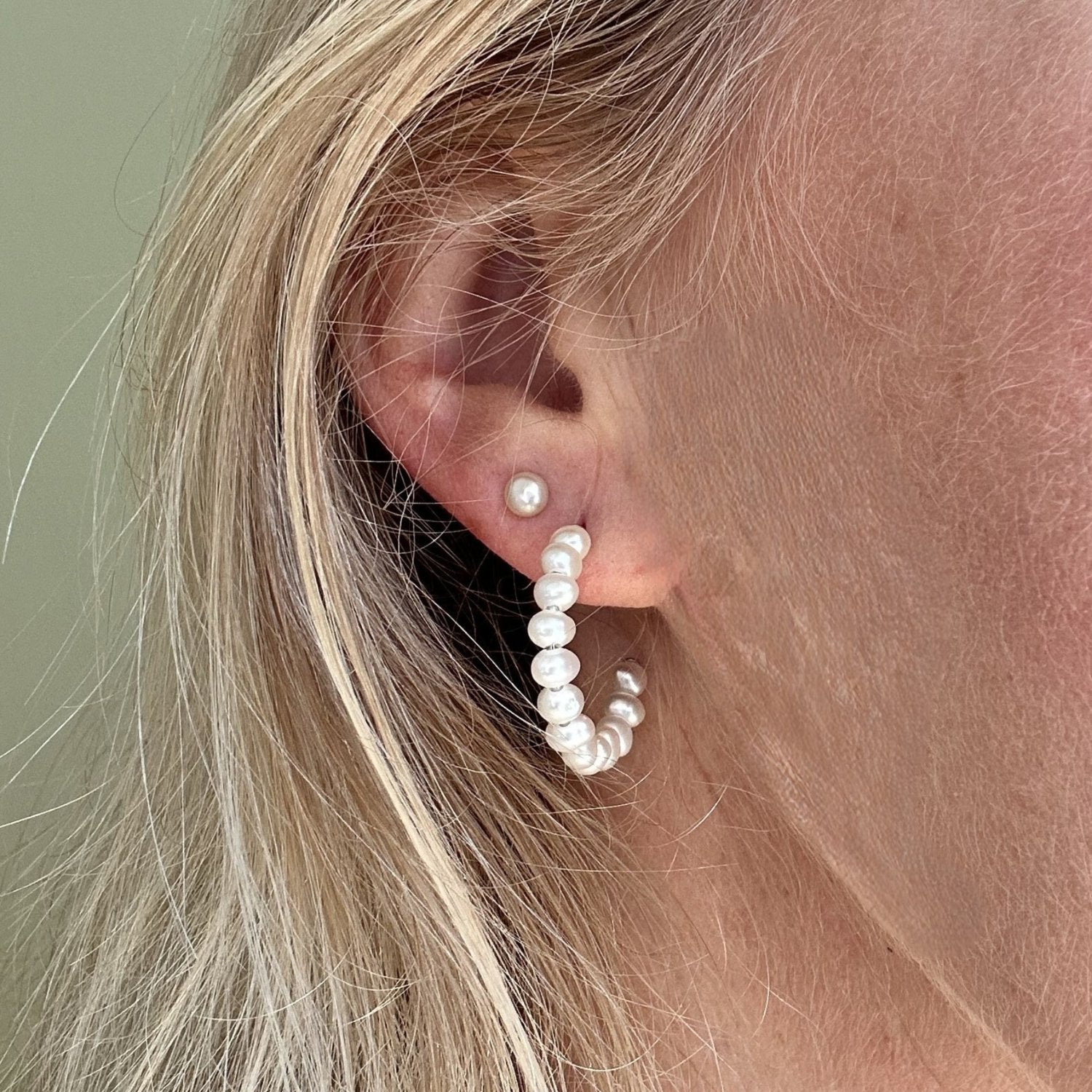 silver pearl hoop earings worn on a model