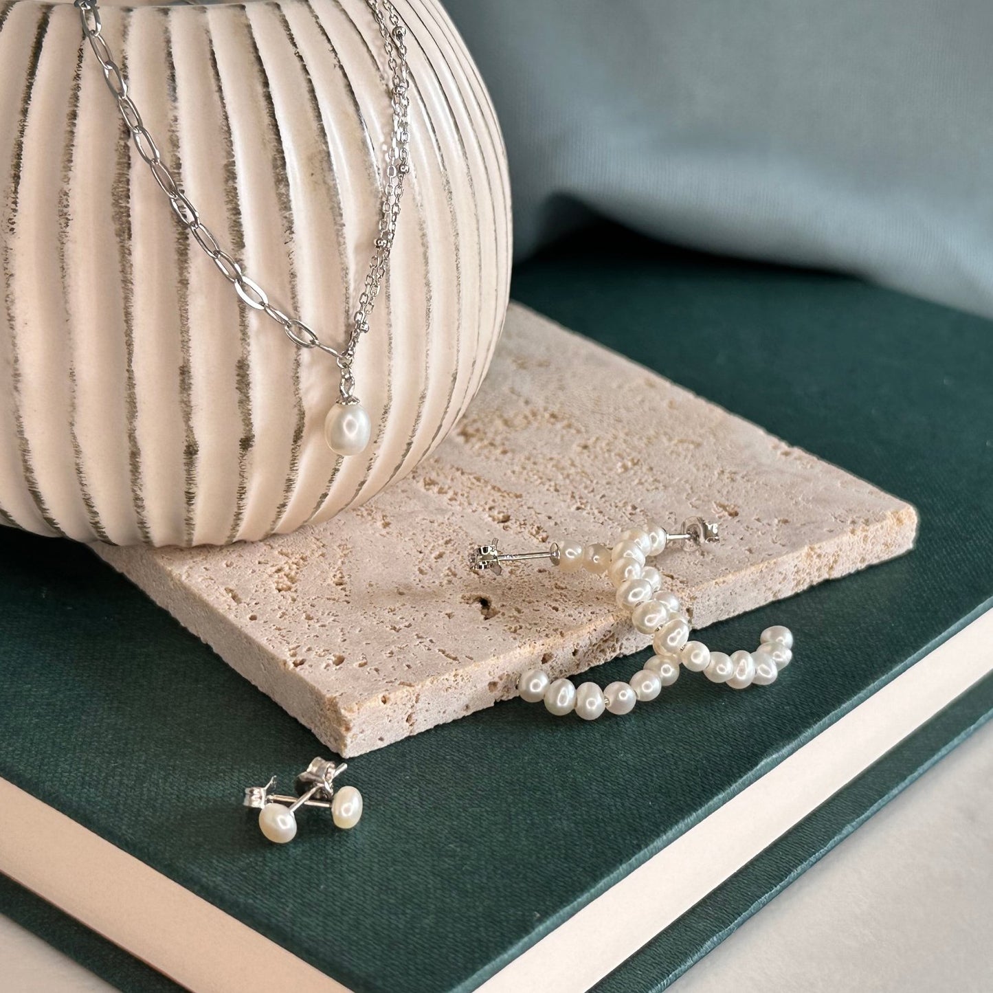 a silver collection laid out on a wooden board