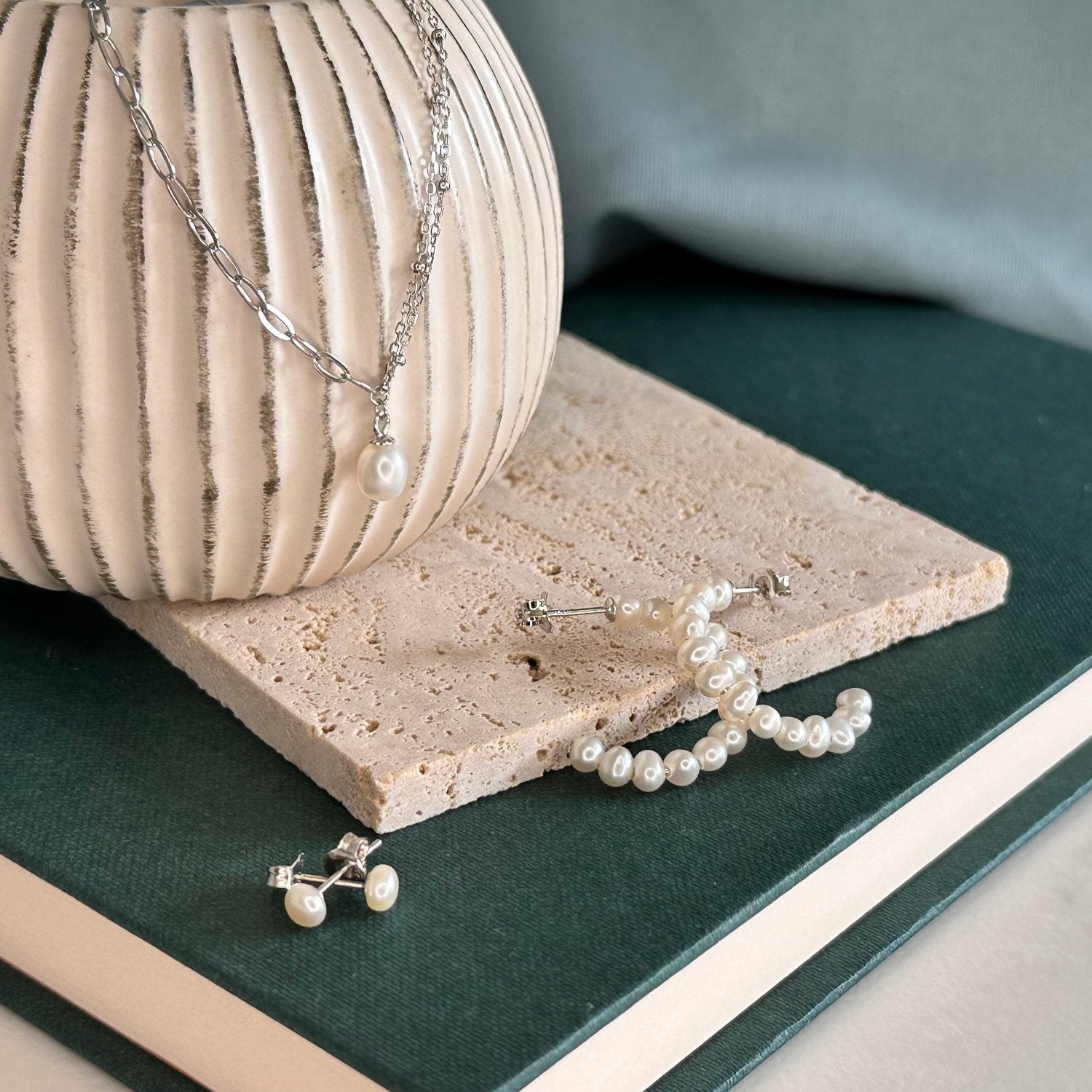 a silver collection laid out on a wooden board