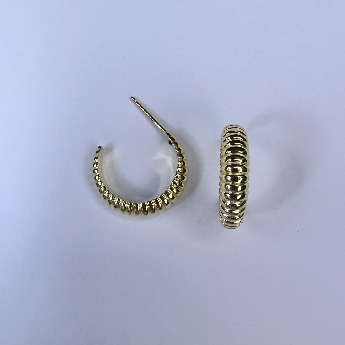 graduating ribbed hoops in silver creating an interesting textured look laid on cream ground