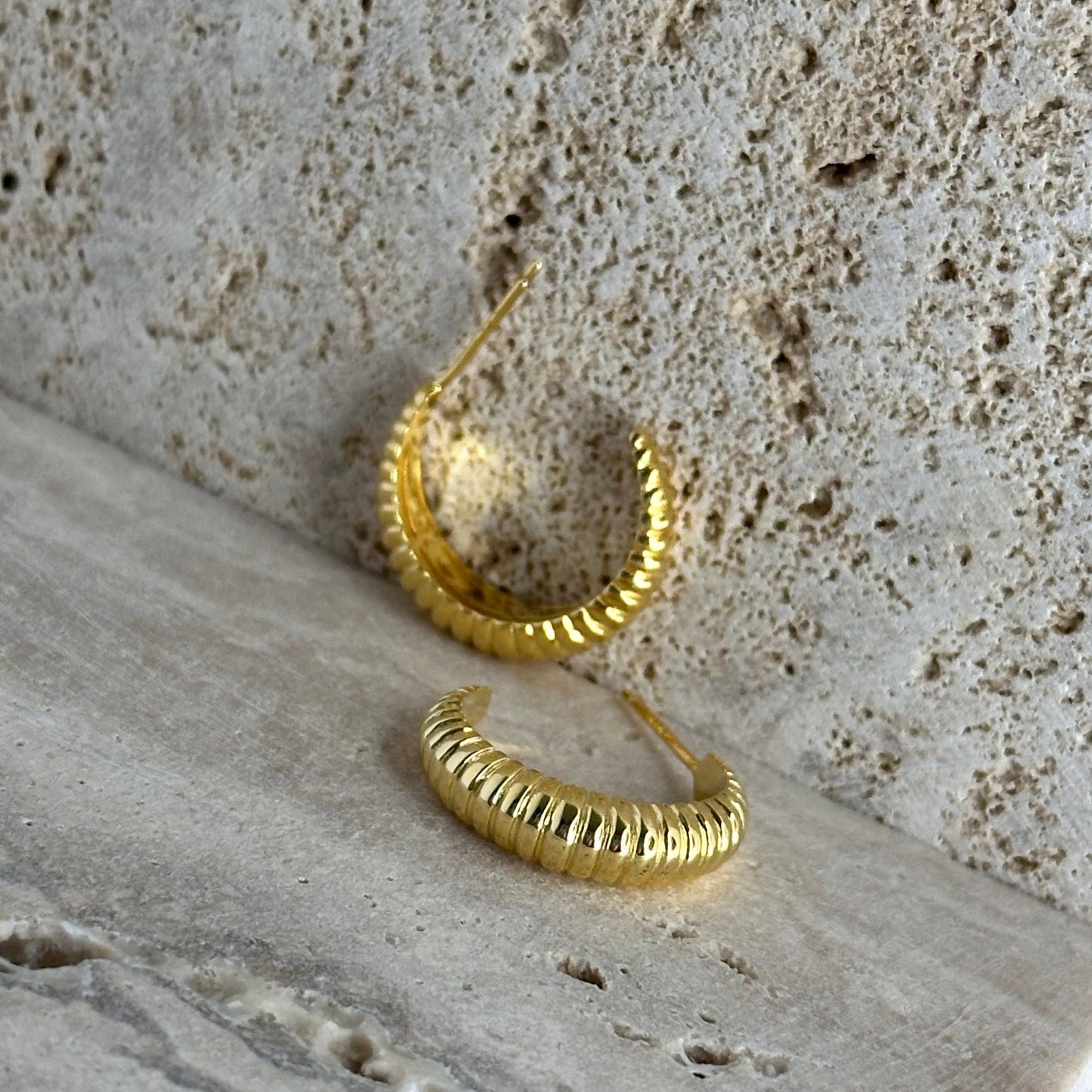 pair of gold hoops on terazzon ground