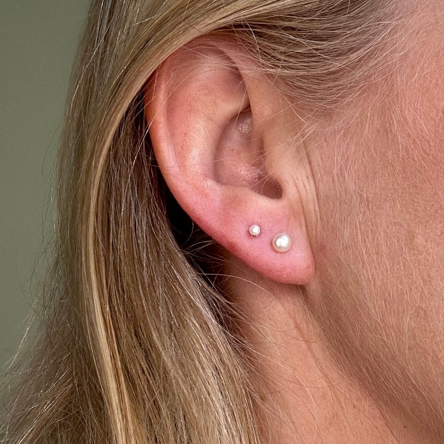 silver pearl stud earings worn on a model
