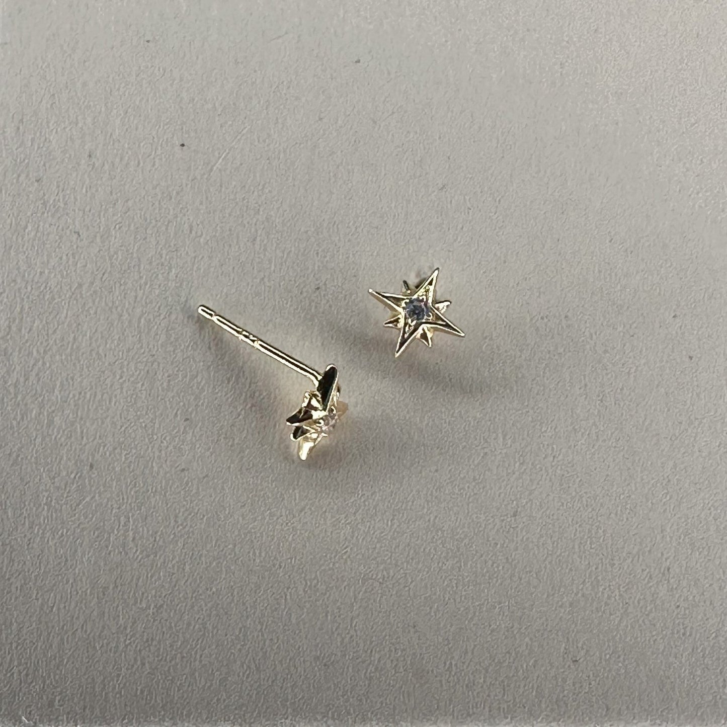 star studs with crystal centre laid on cream ground