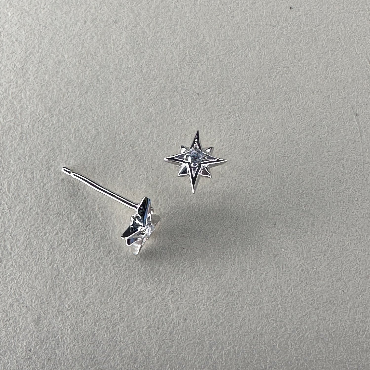 Star shaped studs with crystal centre on cream ground