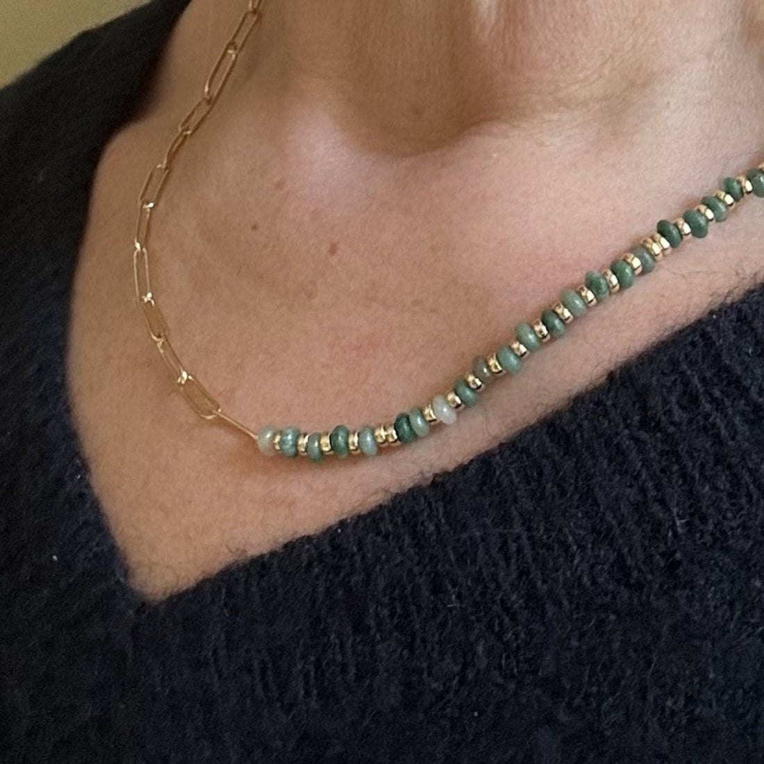 half stone half chain necklace worn on model with blue jumper