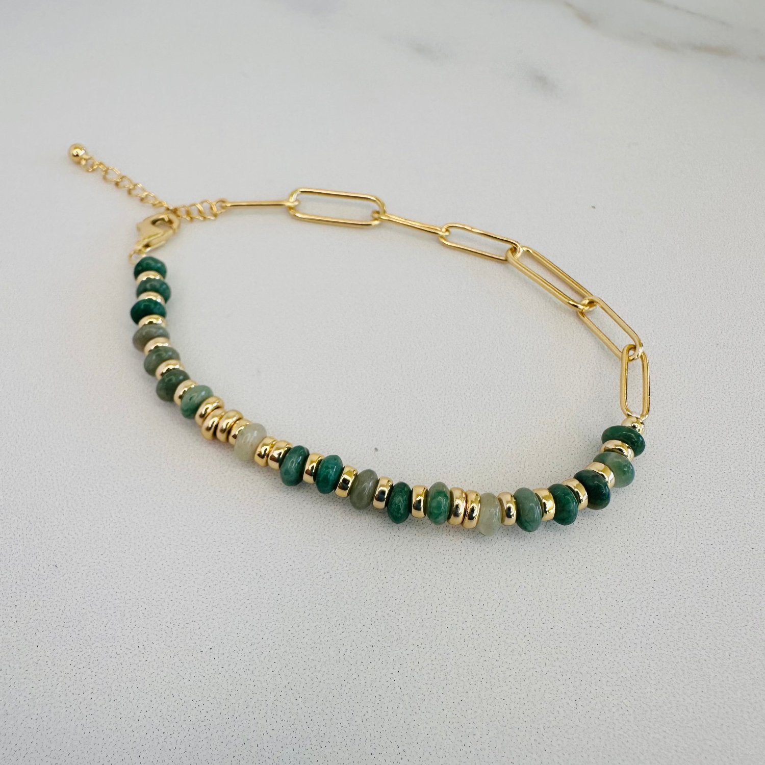 natural african green jade bracelet laid on marble ground