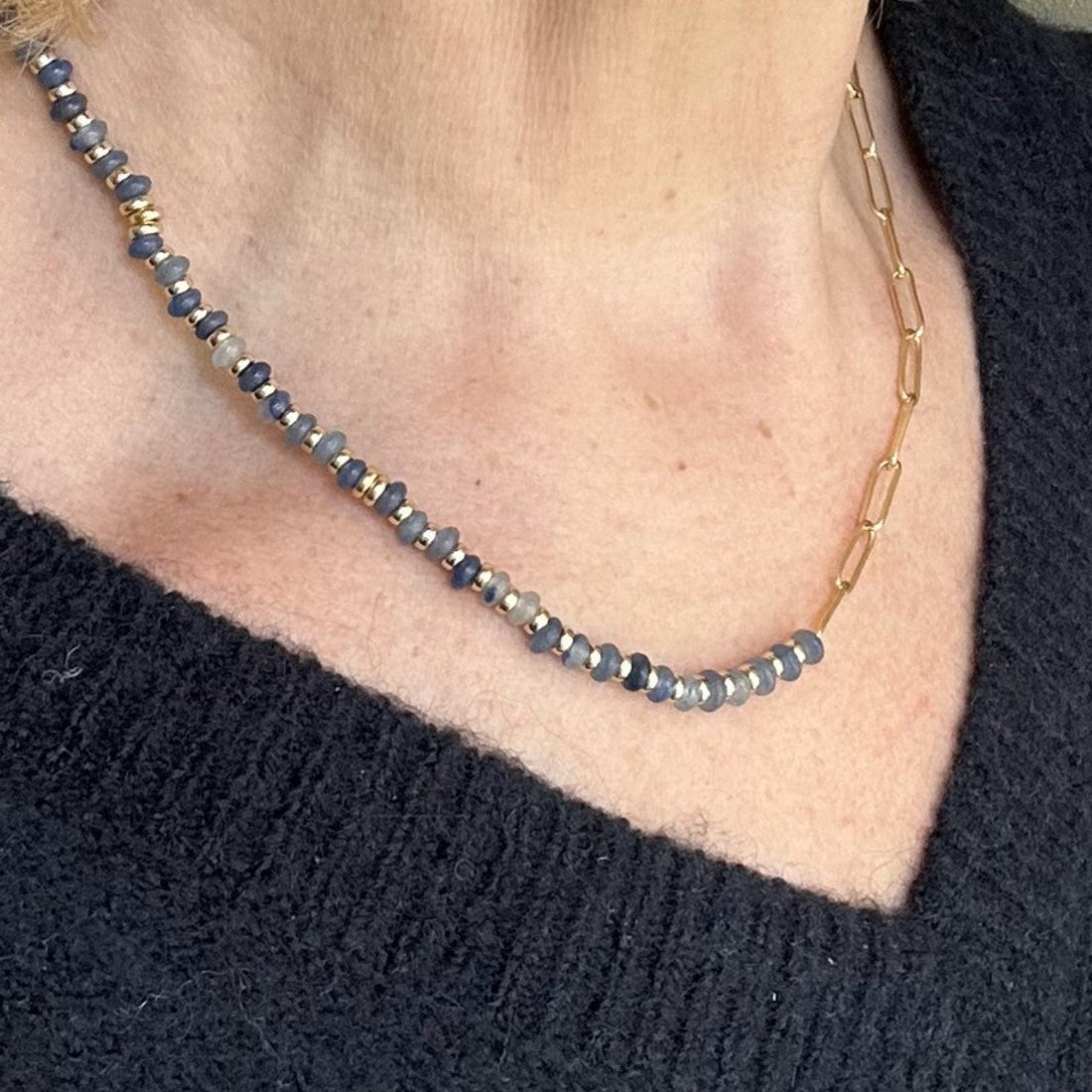 half gemstone half chain nceklace worn on model with blue jumper