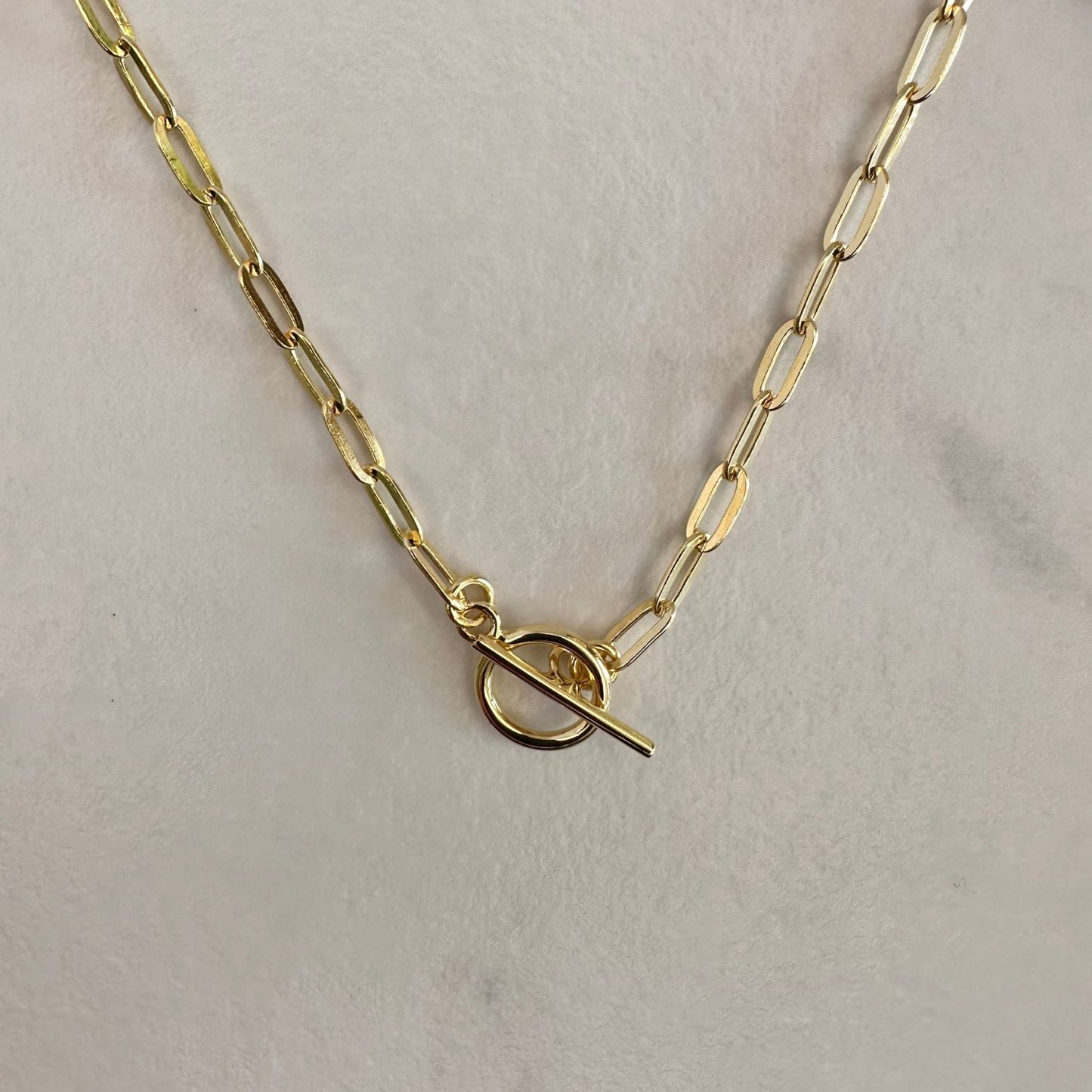 a gold T-bar toggle paperclip chain necklace with a sleek, modern design.