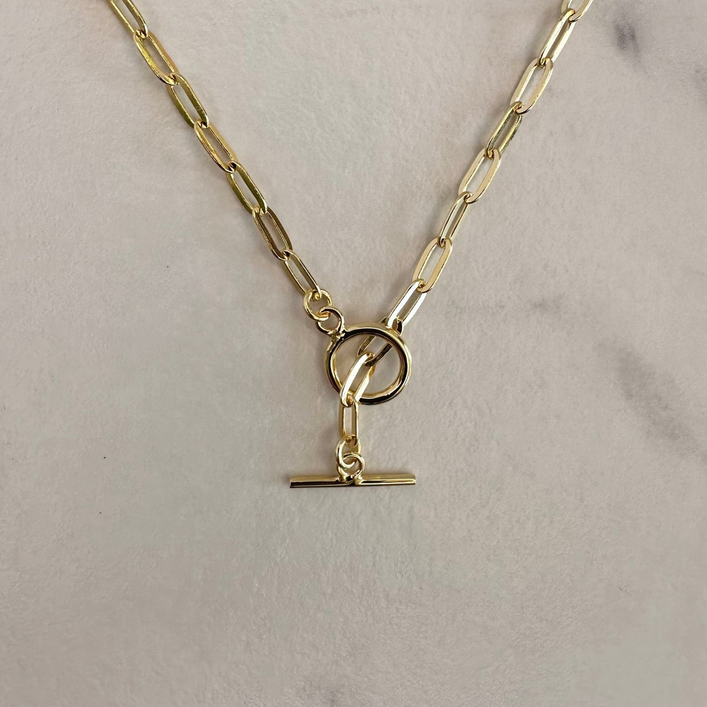 cold chain necklace on grey ground