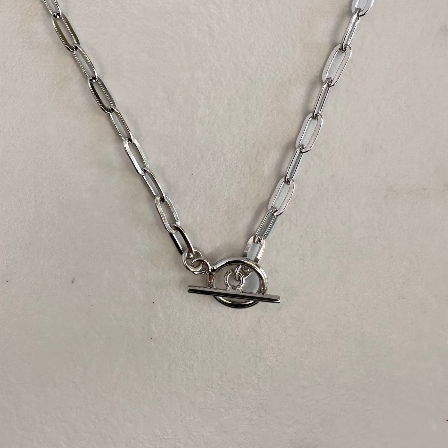 a silver T-bar toggle paperclip chain necklace with a sleek, modern design.