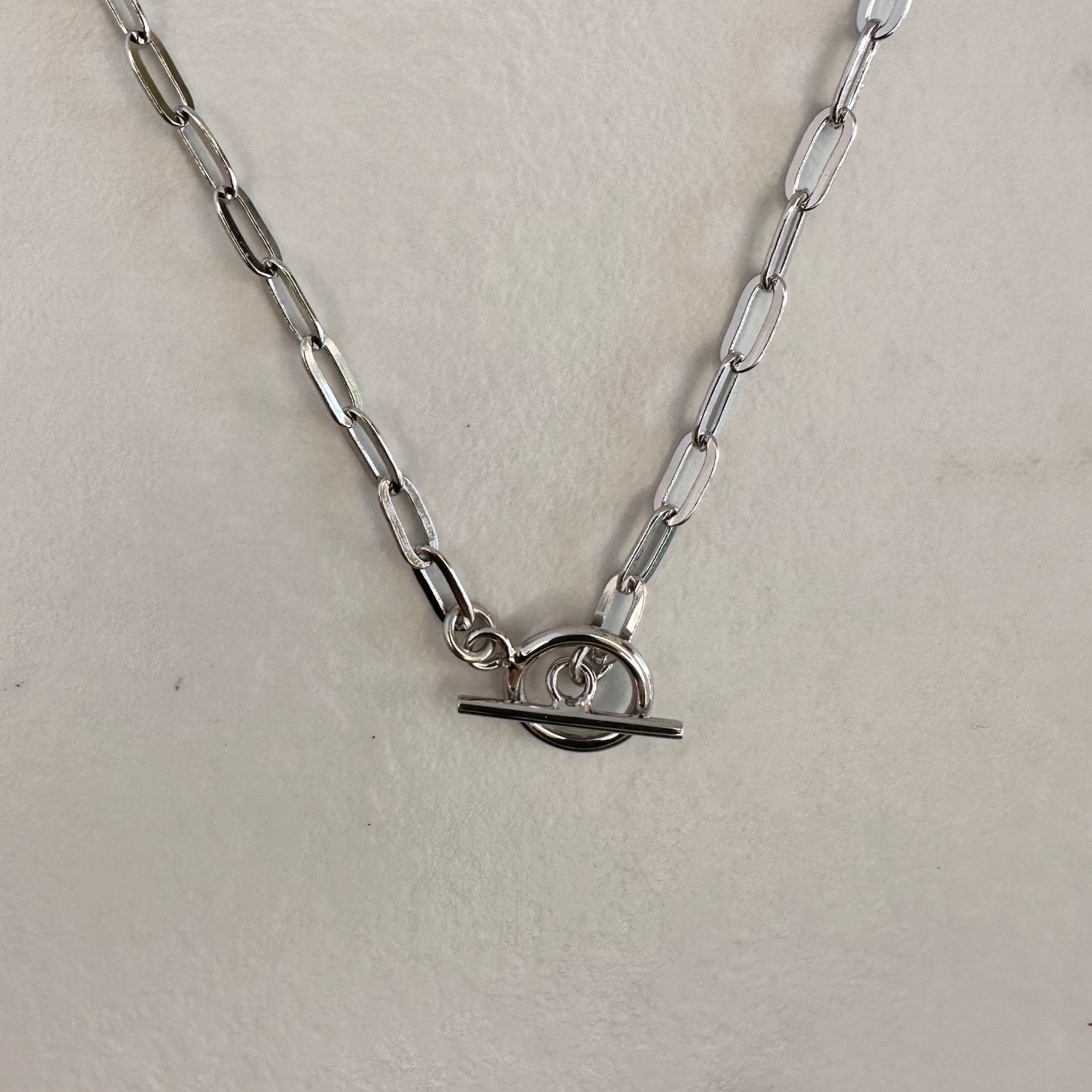 a silver T-bar toggle paperclip chain necklace with a sleek, modern design.