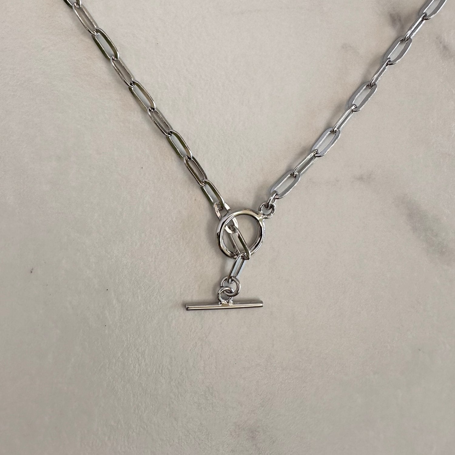Silver chain necklace on grey ground